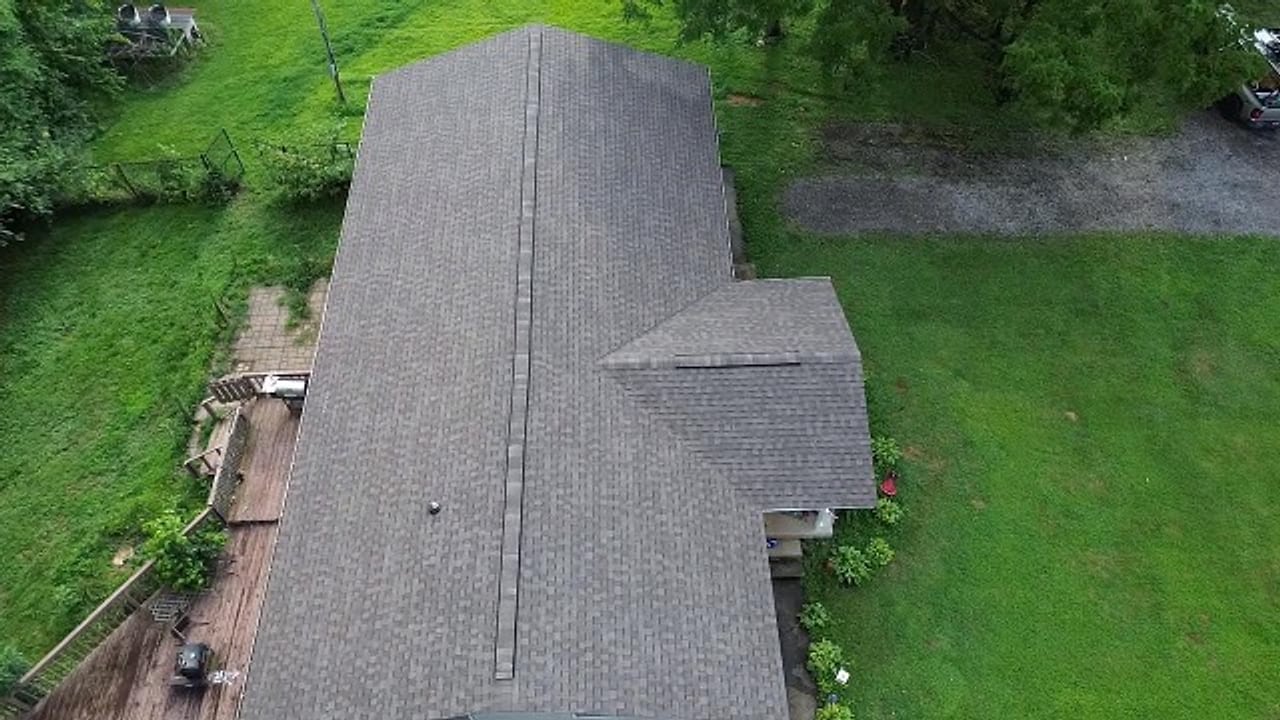 Aerial view of a completed shingle re-roof running the full length of the home