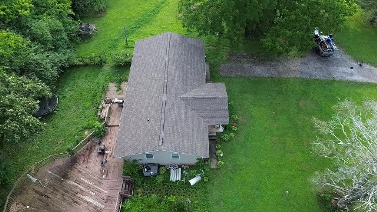 Wide aerial of the property showing the completed roof