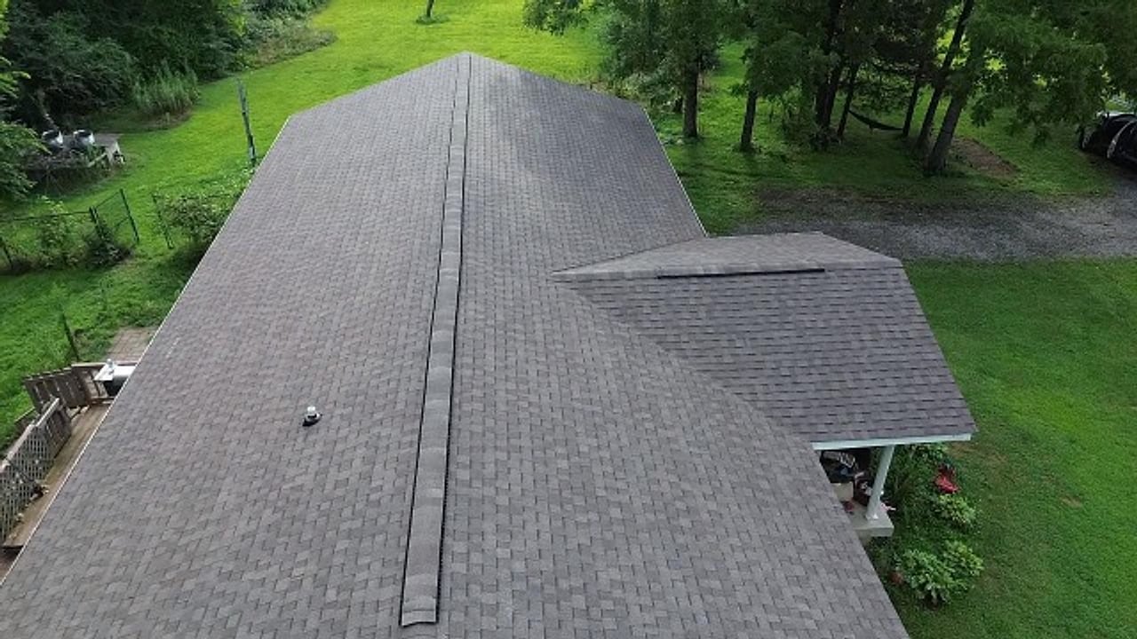 Drone view down the ridge of a freshly installed architectural shingle roof by Affordable Roofing