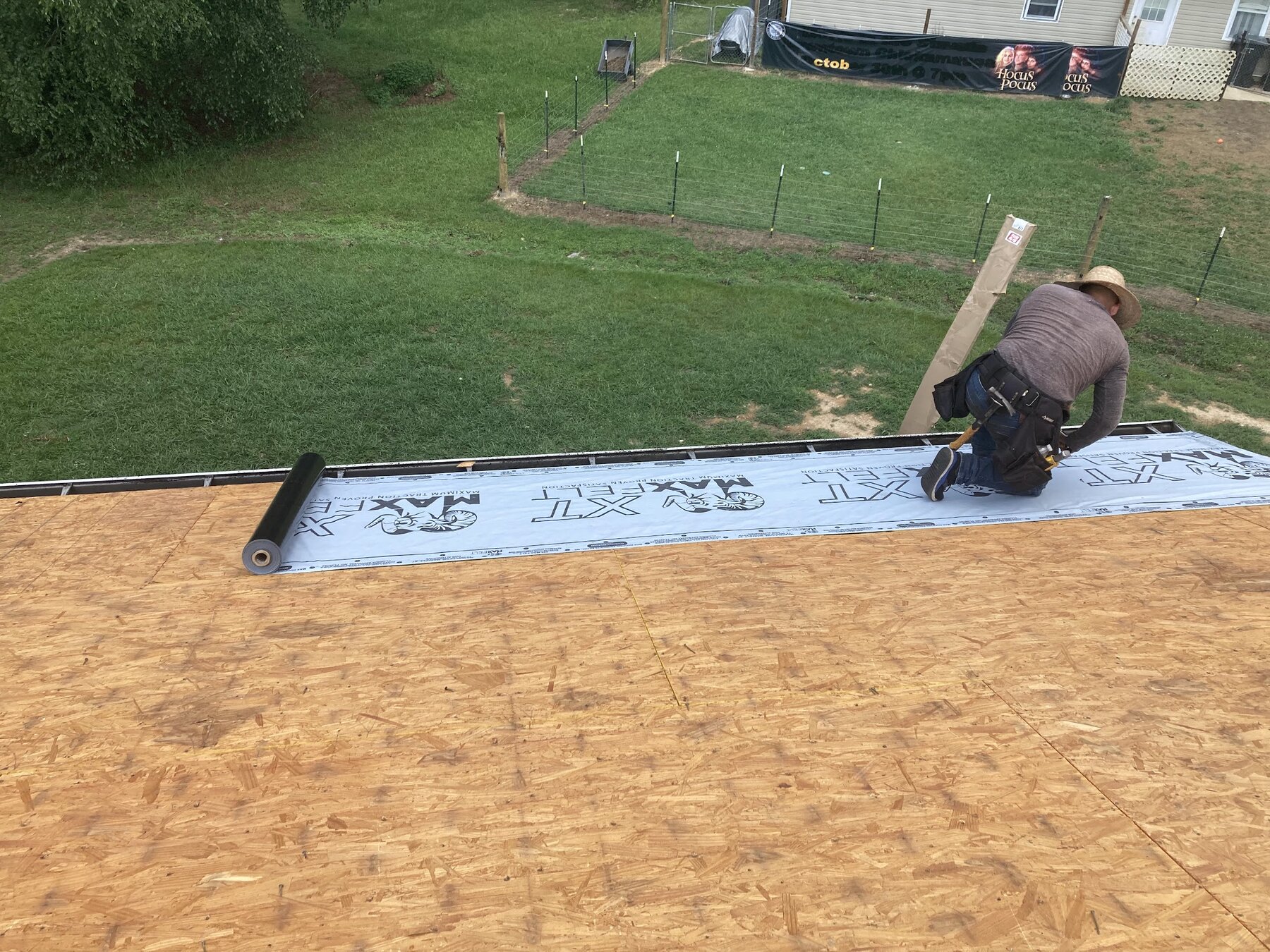 Affordable Roofing crew laying synthetic underlayment